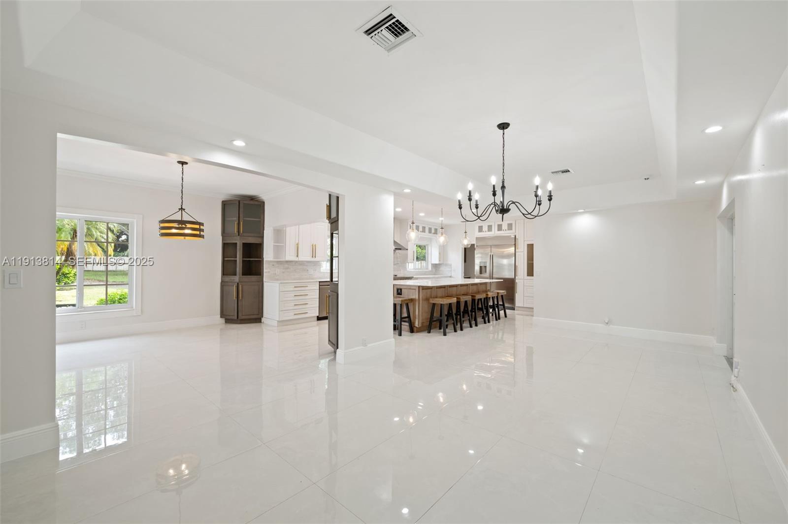 13000 Old Cutler Road Pinecrest, FL 33156 - Photo 5 of 45 a view of a kitchen with a refrigerator a sink and a chandelier