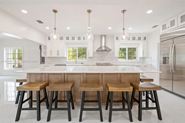 a kitchen with granite countertop white cabinets and a stove