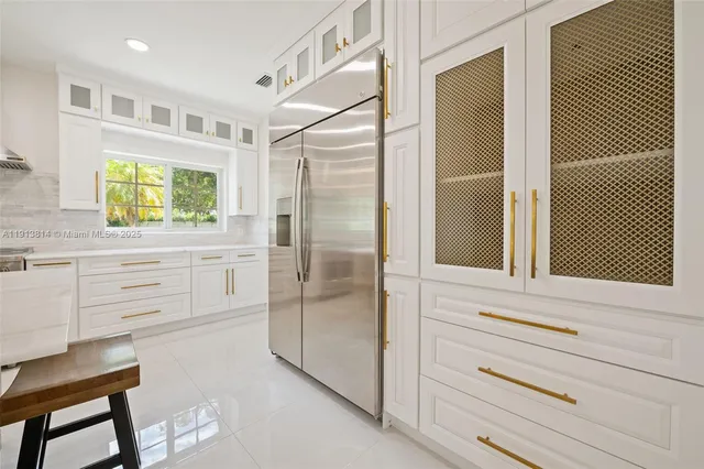 a kitchen with a refrigerator stove and sink