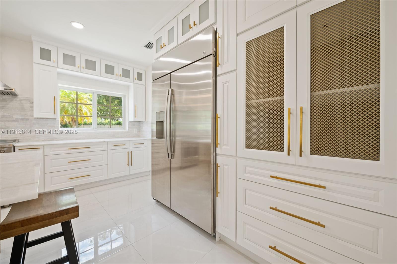 13000 Old Cutler Road Pinecrest, FL 33156 - Photo 9 of 45 a kitchen with white cabinets and a window