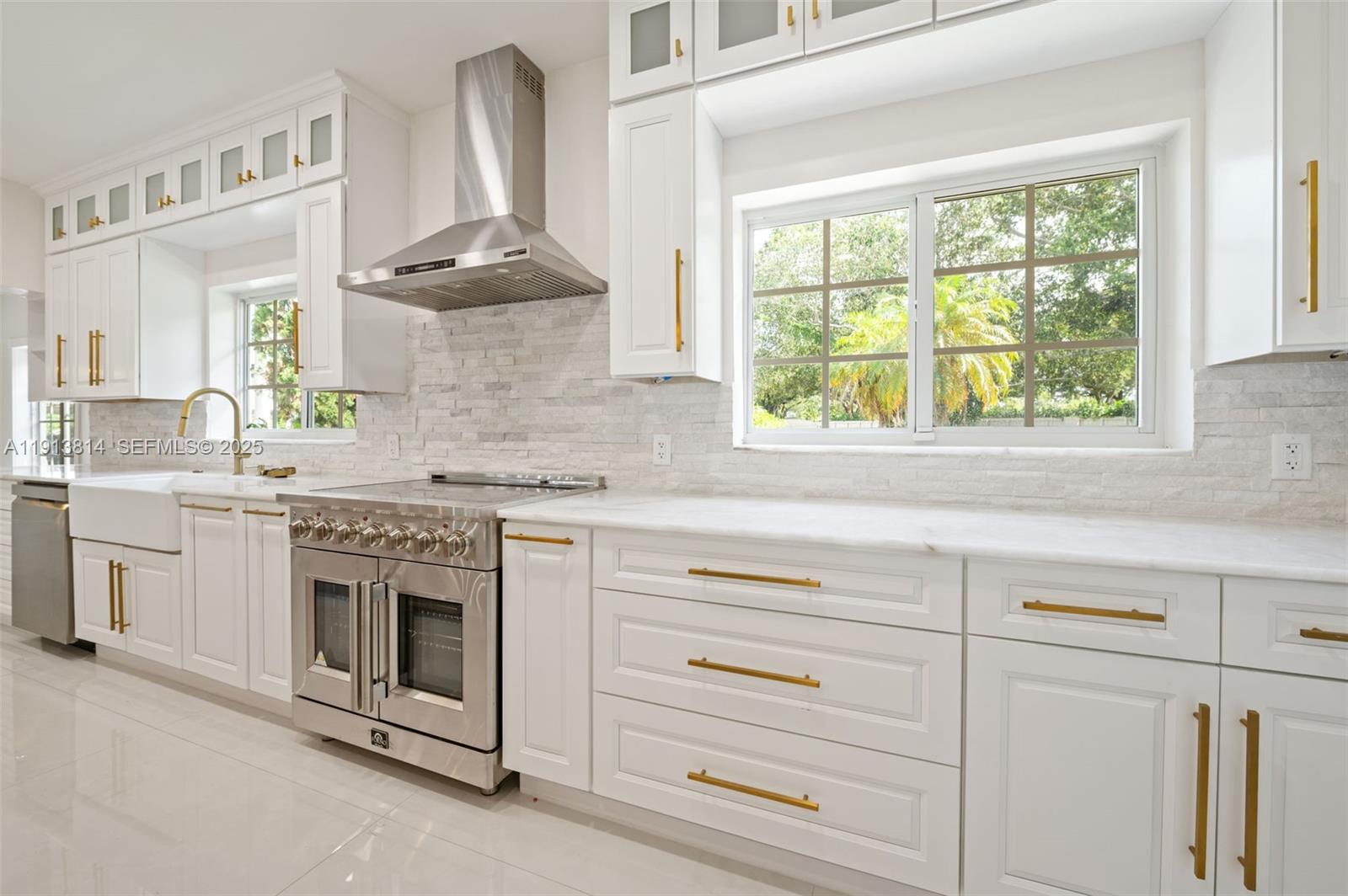 13000 Old Cutler Road Pinecrest, FL 33156 - Photo 10 of 45 a kitchen with granite countertop white cabinets and a stove