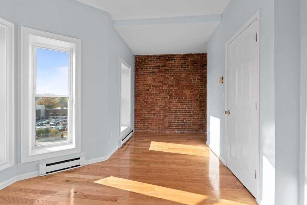 2 Woodbine Street, Unit 2 Boston, MA 02119 - Photo 14 of 26 wooden floor in an empty room with a window
