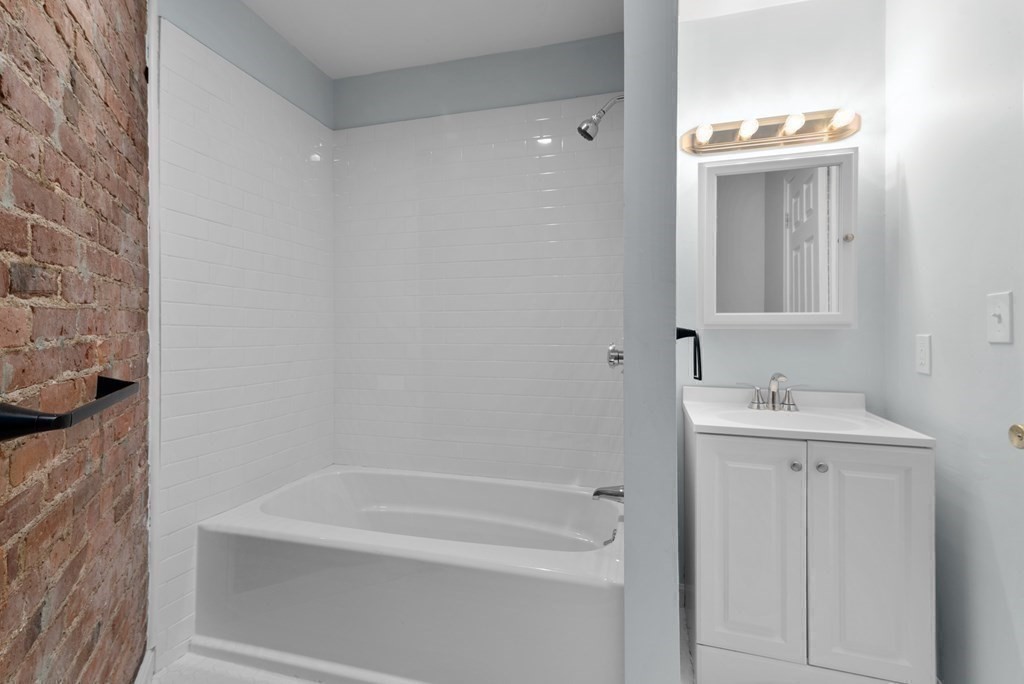 2 Woodbine Street, Unit 2 Boston, MA 02119 - Photo 24 of 26 a bathroom with a sink a toilet and shower