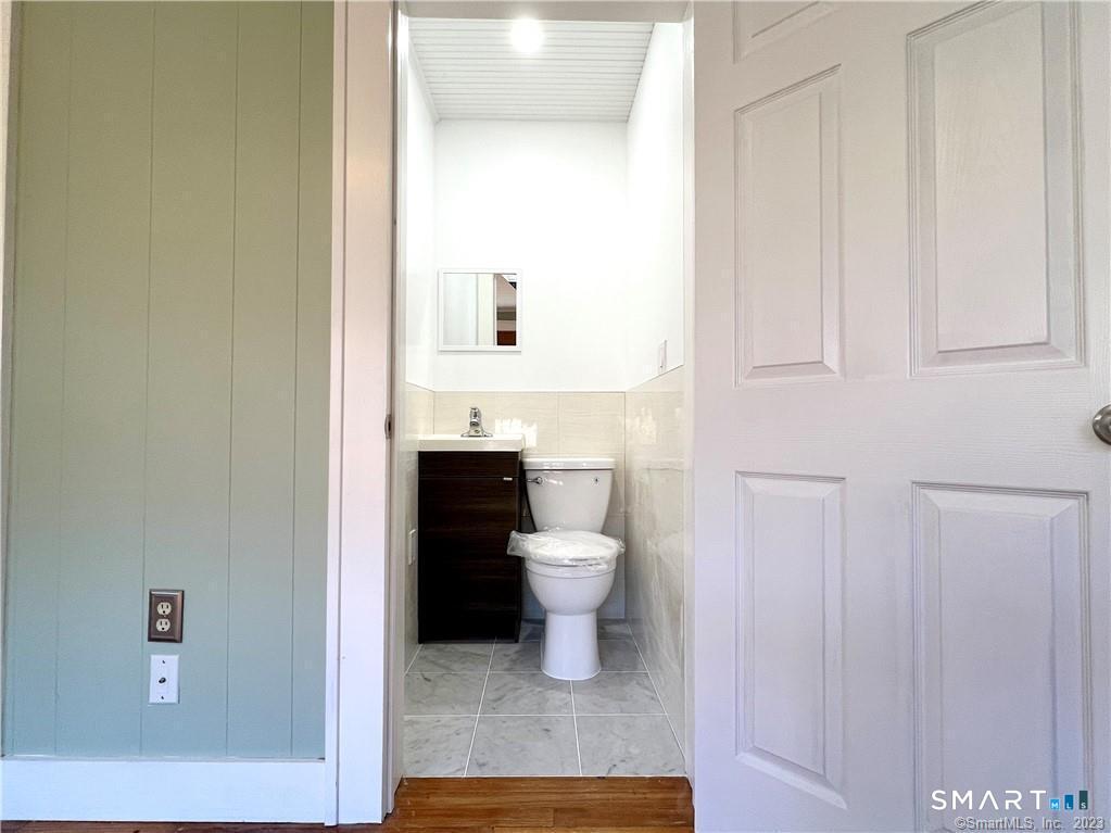 75 Portland Avenue, Unit 77 Redding, CT 06896 - Photo 15 of 23 Half Bath on Main Floor
