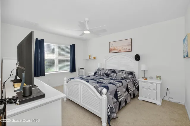 a bed sitting in a bedroom next to a window