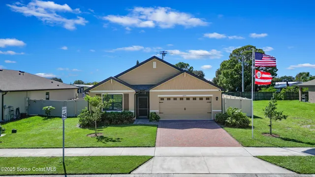 a front view of a house with a garden and plants