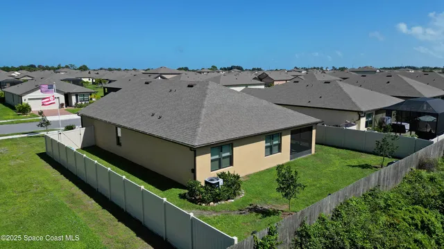 an aerial view of multiple houses with a yard