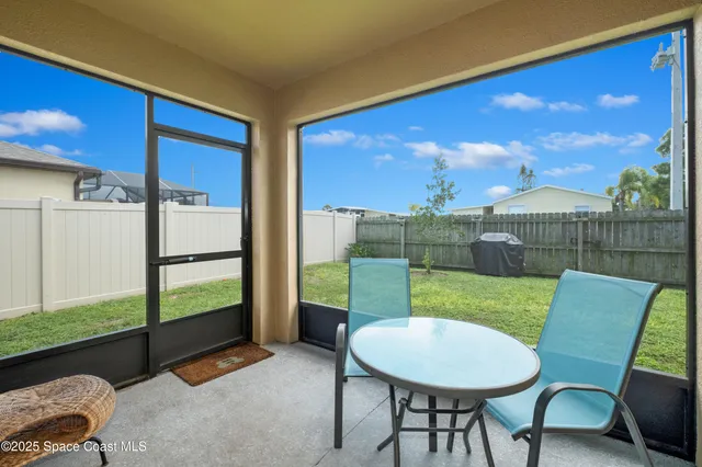 a view of a chairs and table in patio