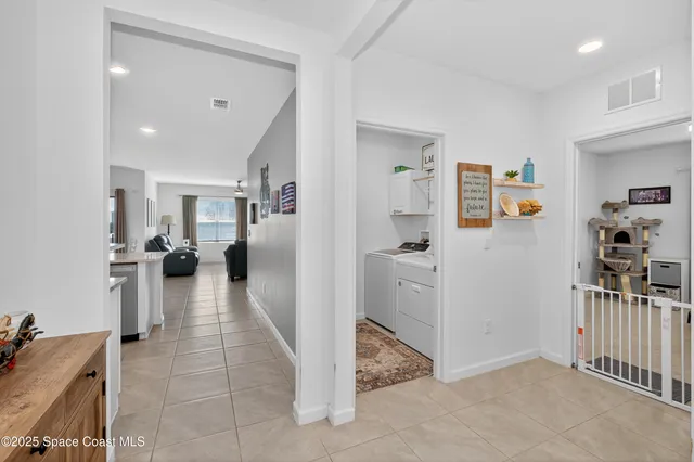 a view of a hallway with workspace and living room