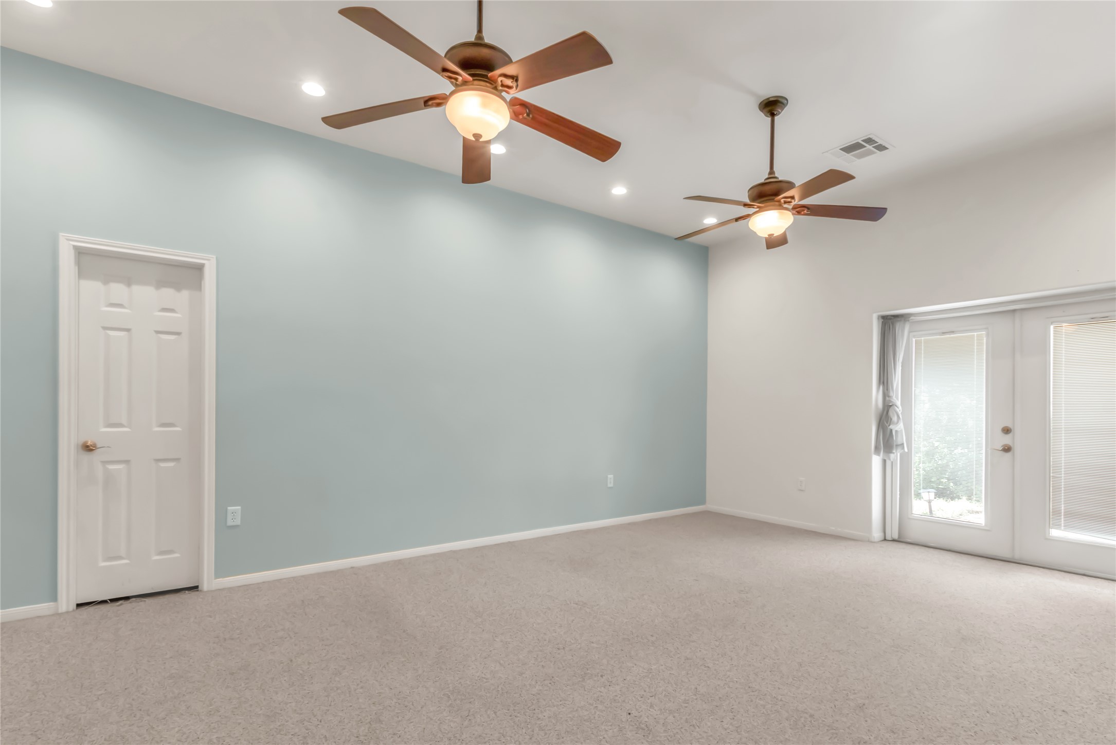 1004 22 Hills Road Gause, TX 77857 - Photo 30 of 37 Bright and airy living area with dual ceiling fans and French doors leading to outdoor space.