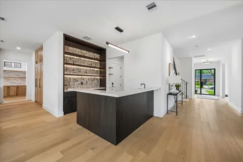 a view of kitchen with wooden floor and electronic appliances