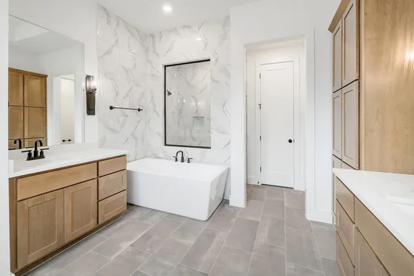 a spacious bathroom with a double vanity sink mirror double and bathtub