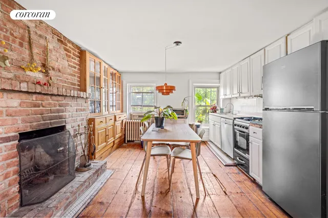 a living room with fireplace furniture and a book shelf