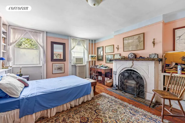 a bedroom with a bed couch and a large window