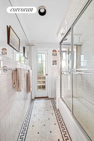 a bedroom with a bed a table and chair with a bookshelf