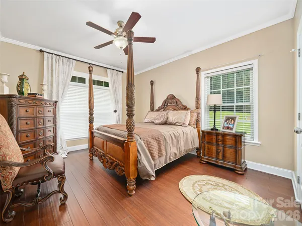 a bedroom with furniture and a wooden floor