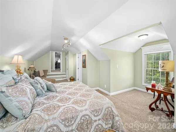 a spacious bathroom with a granite countertop sink and a mirror
