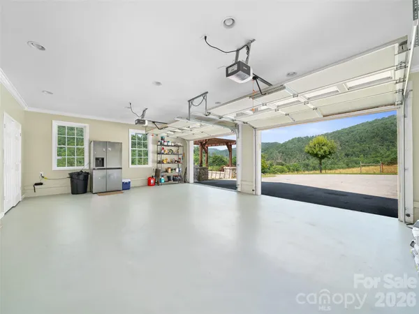 an aerial view of a house with garden space and a lake view