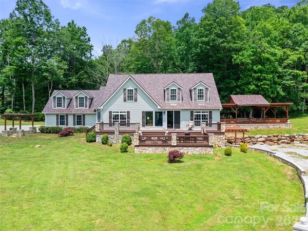 a living room with furniture and large windows