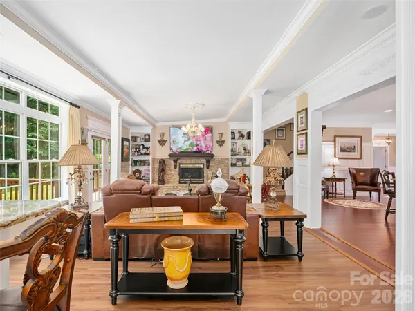 a kitchen with stainless steel appliances a dining table chairs stove refrigerator and cabinets