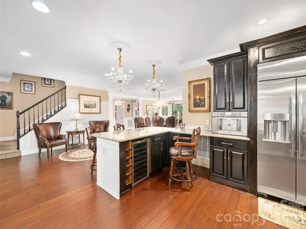 a kitchen with stainless steel appliances granite countertop a sink and stove top oven