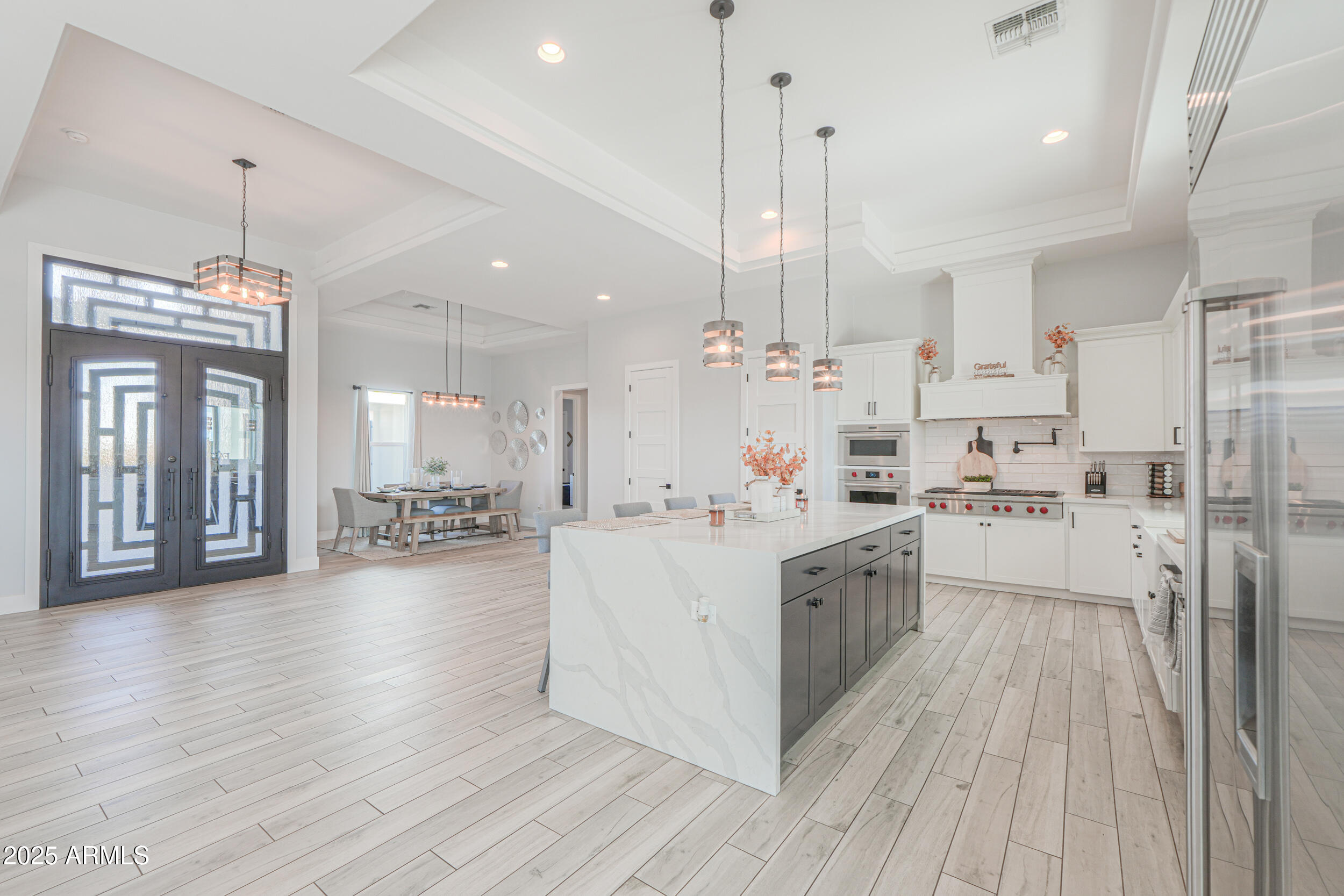 2529 West Magma Road San Tan Valley, AZ 85144 - Photo 12 of 93 a large kitchen with stainless steel appliances kitchen island granite countertop a large center island a stove a refrigerator and a view of living room