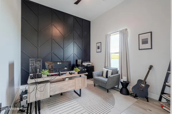 a view of a hallway with wooden floor and closet area
