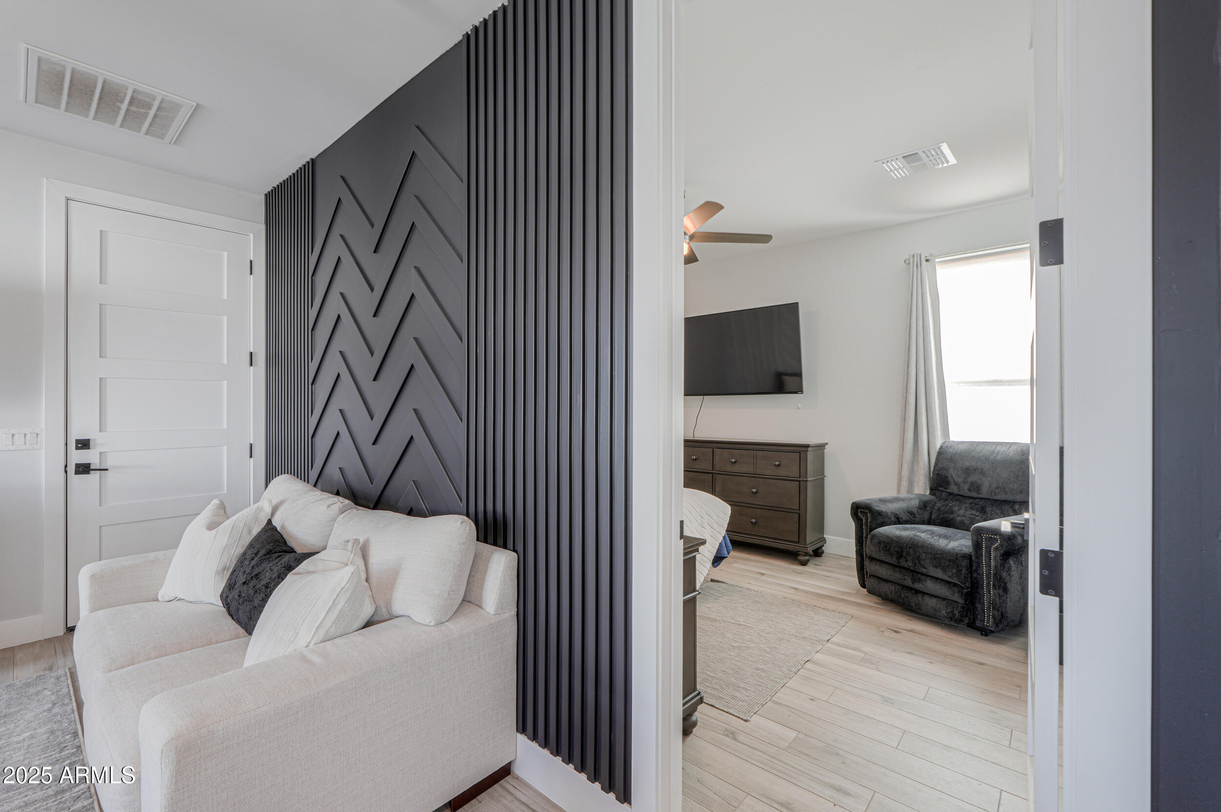 2529 West Magma Road San Tan Valley, AZ 85144 - Photo 71 of 93 a hallway with a couch and a flat screen tv