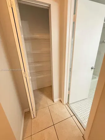 a view of a hallway to rooms