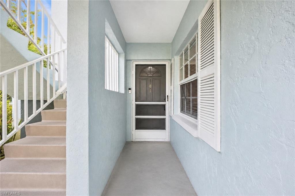 5737 Whitaker Road, Unit C101 Naples, FL 34112 - Photo 19 of 28 a view of a hallway with staircase