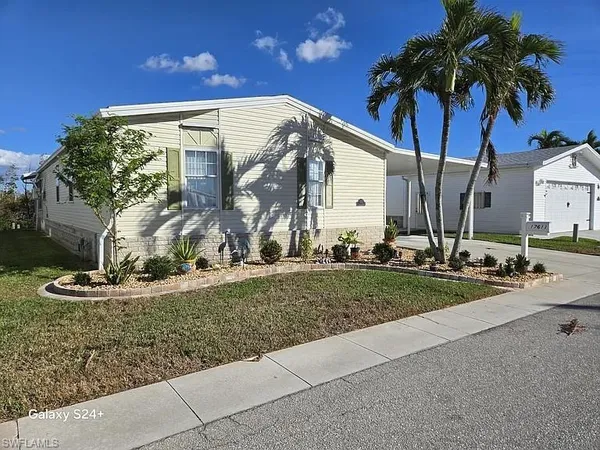 a view of a house with outdoor space and palm trees