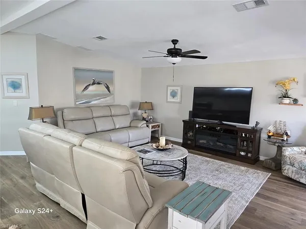 a living room with furniture and a flat screen tv