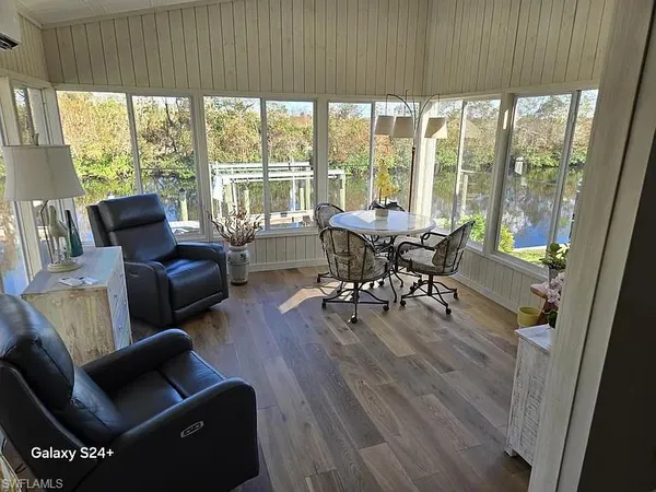 a living room with furniture and floor to ceiling windows