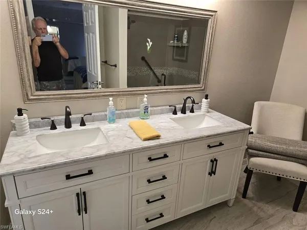 a bathroom with a sink vanity and a mirror