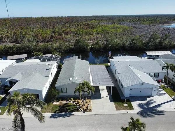 an aerial view of a house with a yard