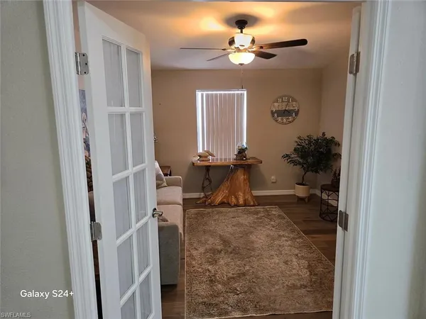 a living room with furniture and a chandelier
