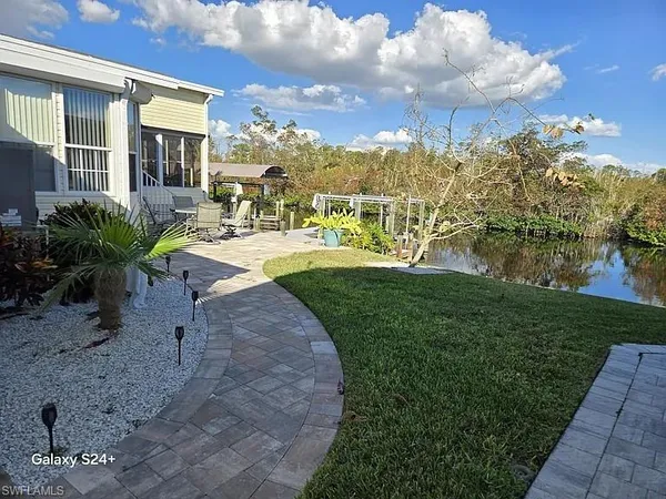 a view of a backyard with plants and a garden