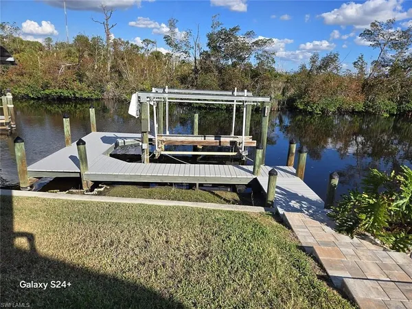 a view of house with swimming pool and outdoor seating