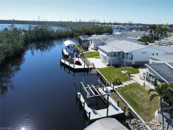 an aerial view of a house with swimming pool a yard and outdoor seating