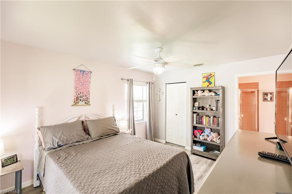 2750 Kings Lake Boulevard, Unit 204 Naples, FL 34112 - Photo 18 of 31 a bedroom with a bed furniture and a flat screen tv