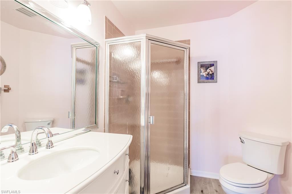 2750 Kings Lake Boulevard, Unit 204 Naples, FL 34112 - Photo 21 of 31 a bathroom with a sink toilet and shower