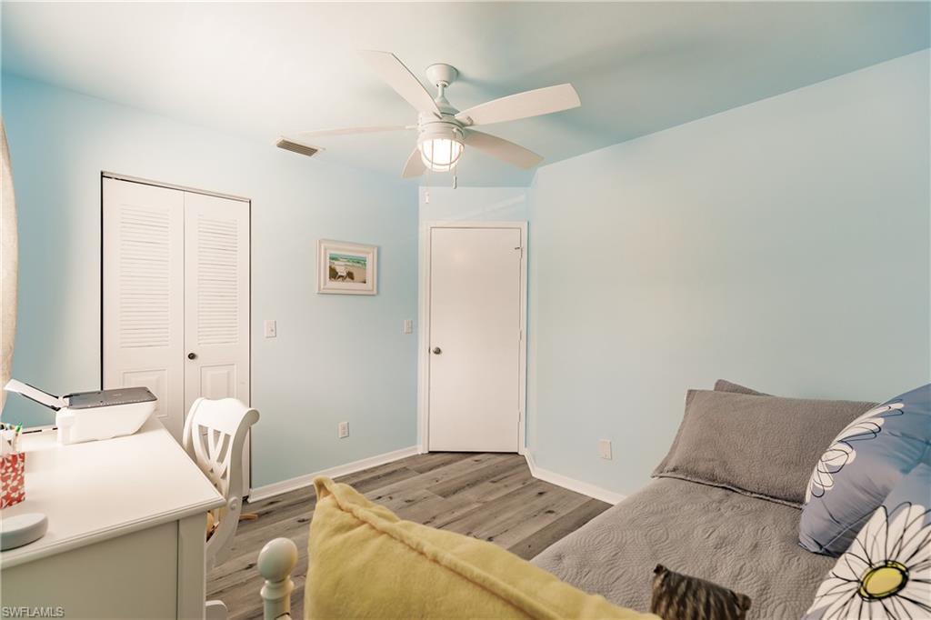 2750 Kings Lake Boulevard, Unit 204 Naples, FL 34112 - Photo 24 of 31 a bedroom with a bed and a table in it