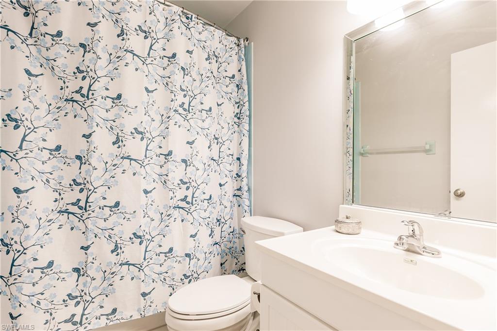 2750 Kings Lake Boulevard, Unit 204 Naples, FL 34112 - Photo 25 of 31 a bathroom with a sink toilet and shower