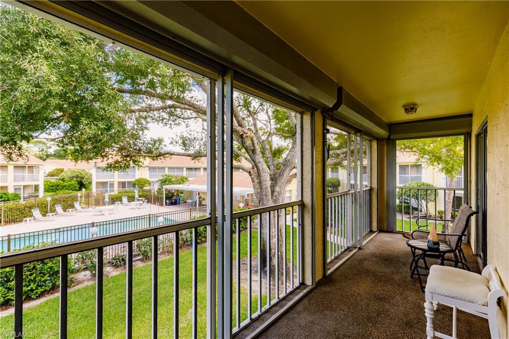 2750 Kings Lake Boulevard, Unit 204 Naples, FL 34112 - Photo 29 of 31 a view of a city from a balcony