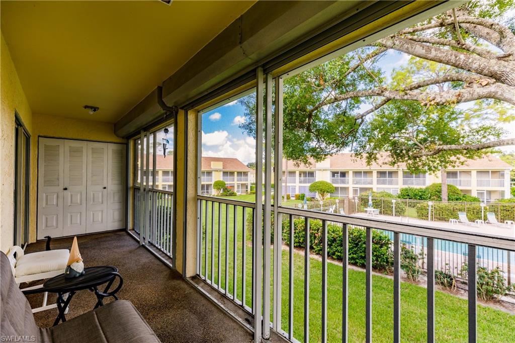 2750 Kings Lake Boulevard, Unit 204 Naples, FL 34112 - Photo 30 of 31 a view of a porch with furniture