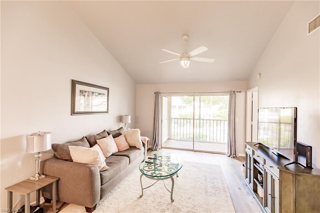 2750 Kings Lake Boulevard, Unit 204 Naples, FL 34112 - Photo 9 of 31 a living room with furniture and a large window