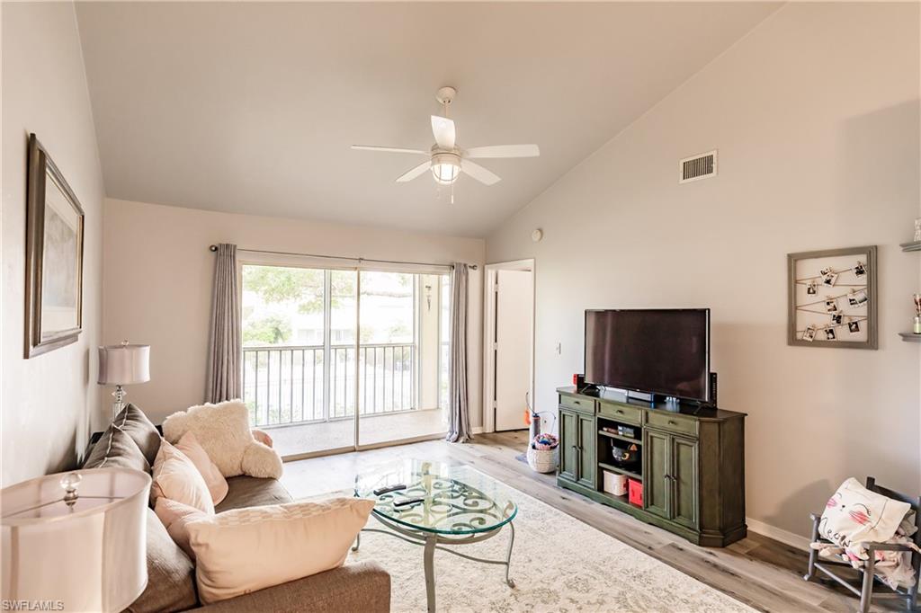 2750 Kings Lake Boulevard, Unit 204 Naples, FL 34112 - Photo 10 of 31 a living room with furniture and a flat screen tv