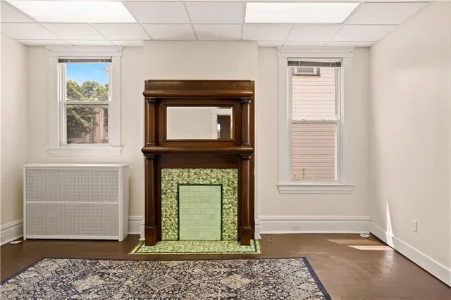 an entryway space with window and wooden floor