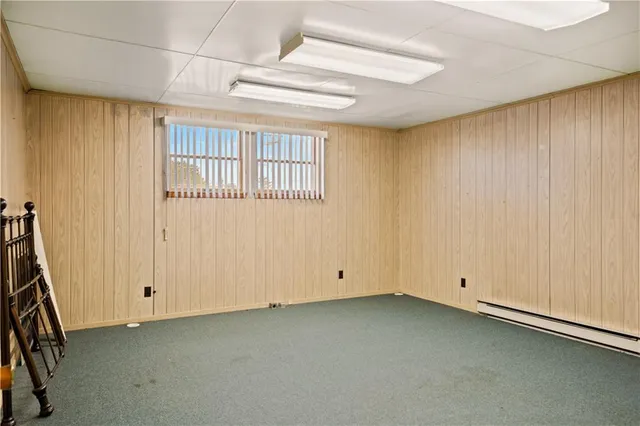 a view of a hallway with entryway and wooden floor