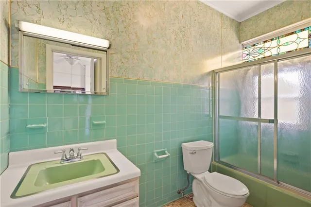 a view of an empty room with window and chandelier fan